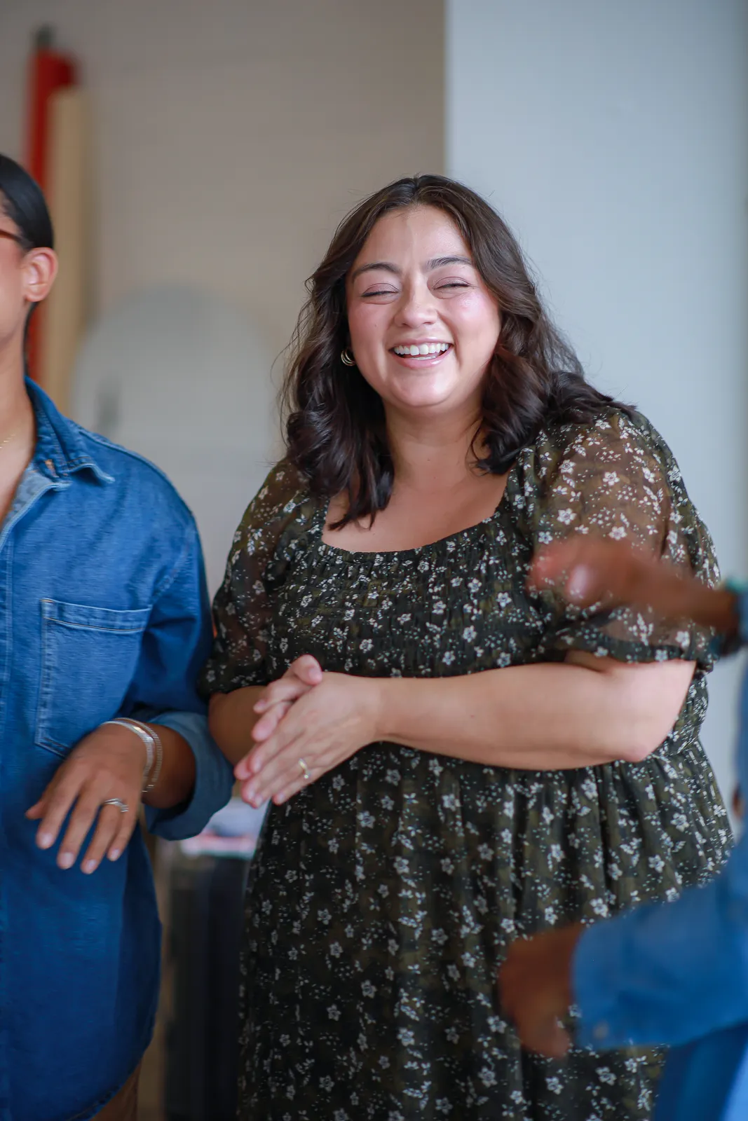 A woman laughing with friends