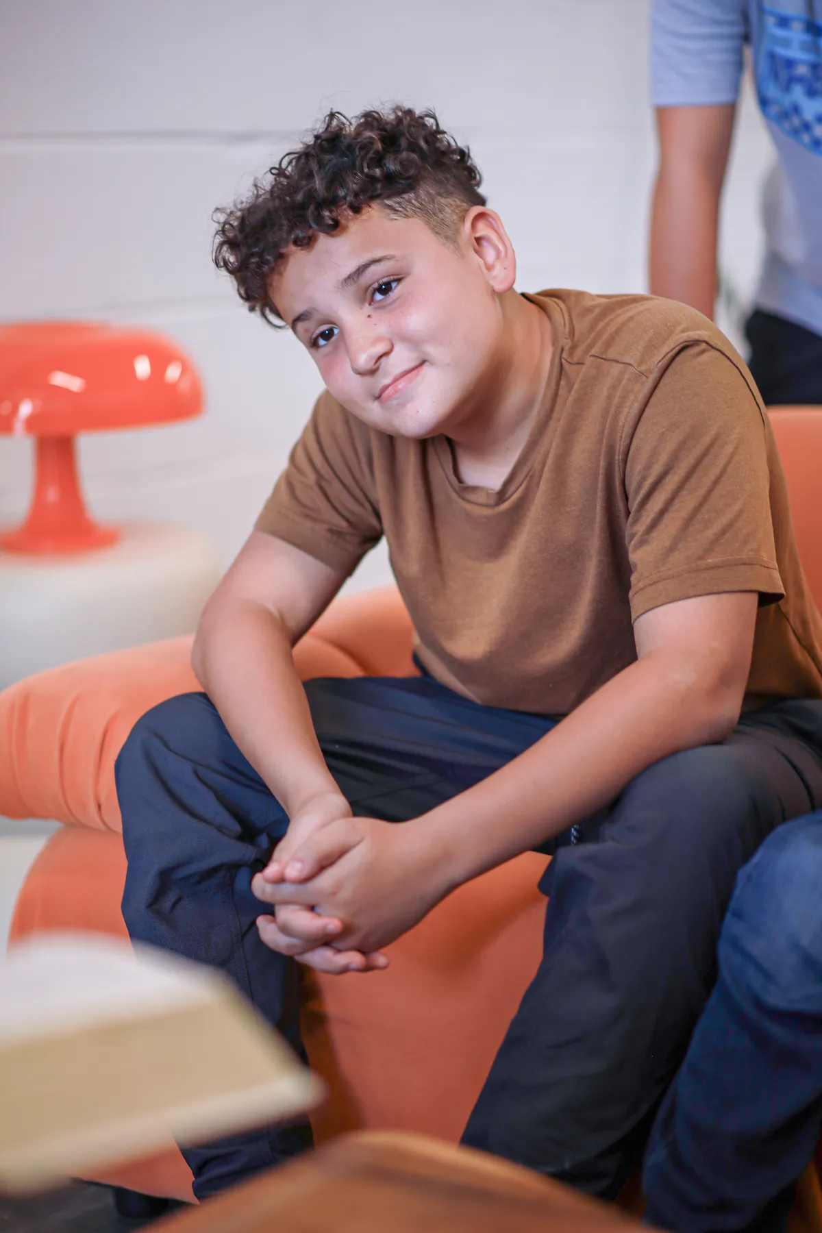 A young man smiling from the couch