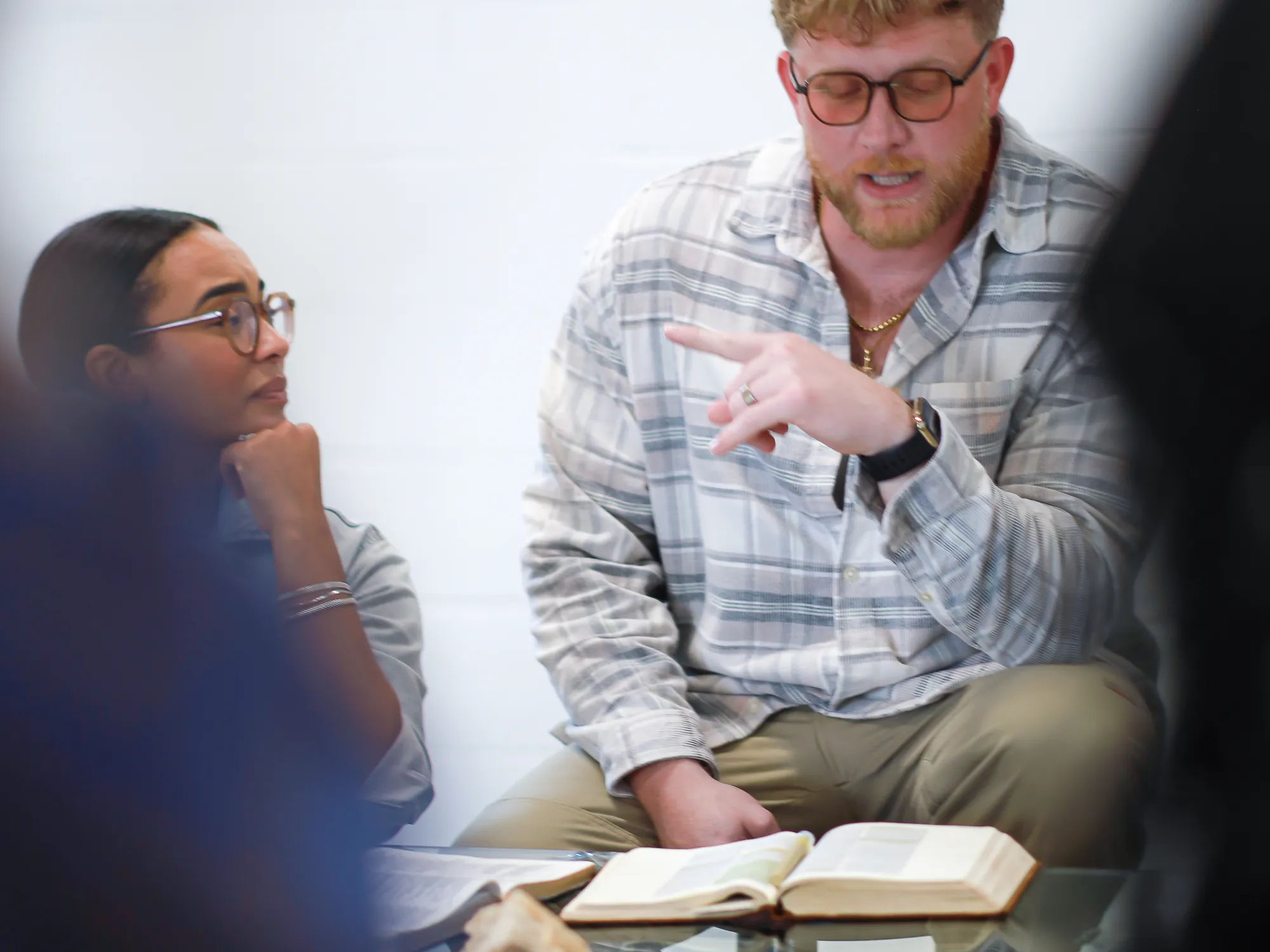 Friends at the table with bread and open Bibles