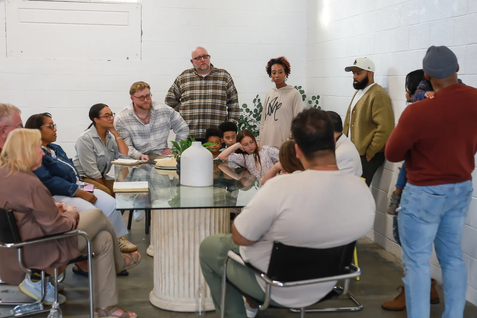 A room full of people gathered around the table